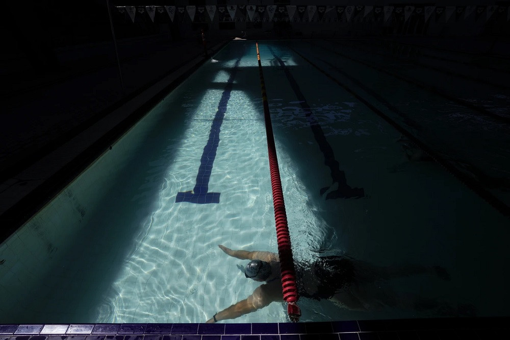 Elizabeth Lopez changes lanes as she swims at a public pool July 20, 2023, in Mexicali, Mexico.jpg
