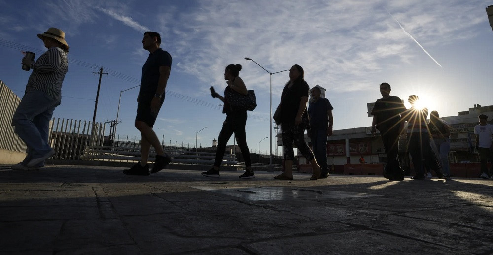 People wait in line to cross the border to Calexico, Calif., Thursday, July 20, 2023, in Mexicali, Mexico.jpg